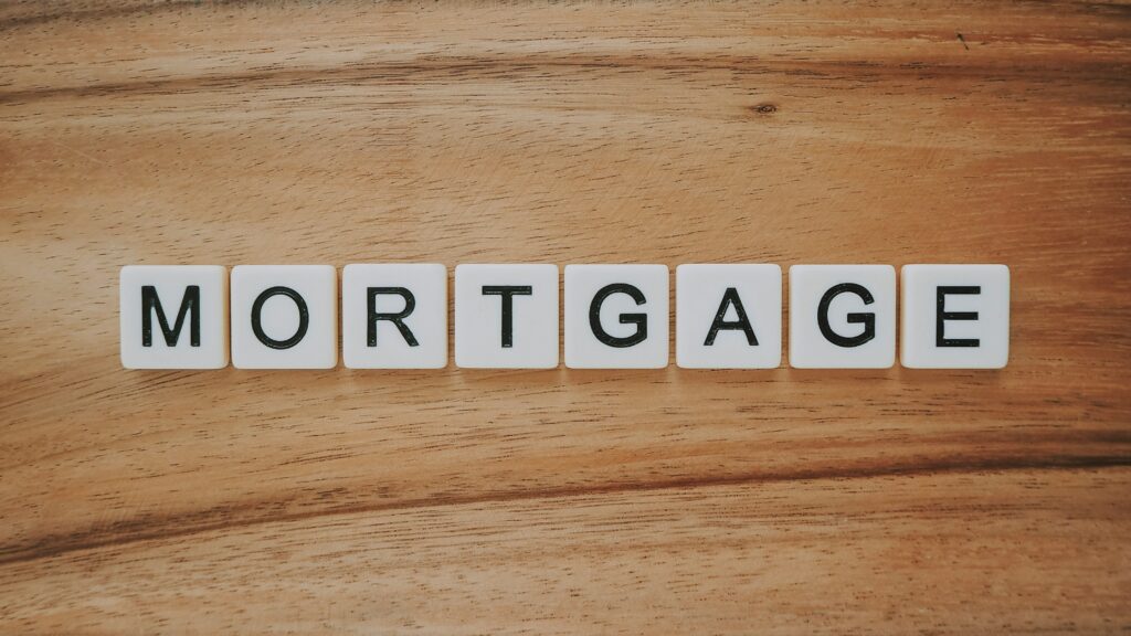 Mortgage: The word 'mortgage' spelled out using Scrabble tiles, arranged neatly on a surface. The distinctive letter tiles showcase the term in a playful and engaging manner, adding a touch of creativity to the representation of home financing and real estate.