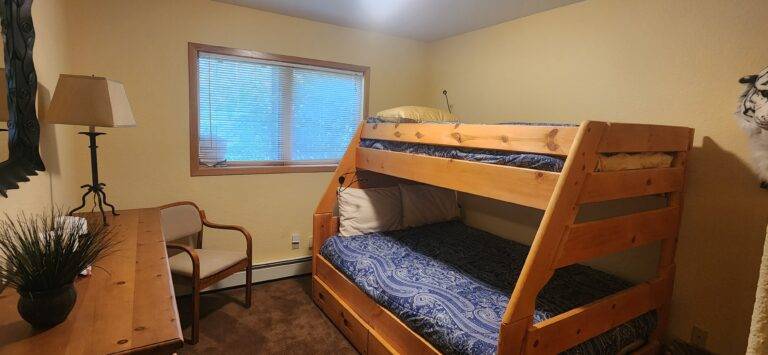 Bedroom with bunk beds with blue bedding